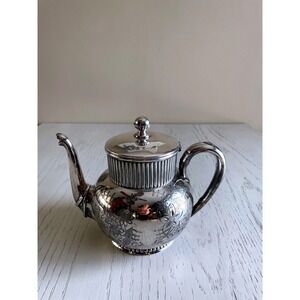 Victorian Aesthetic Movement Wilcox silver-plated teapot with floral engravings.